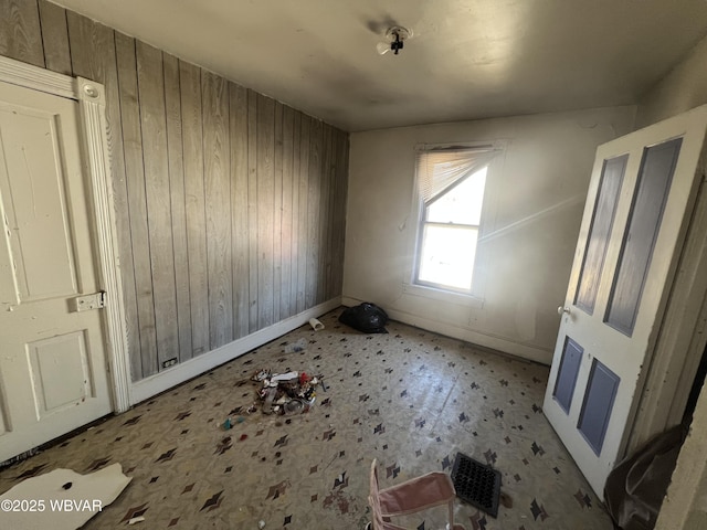 spare room featuring wood walls