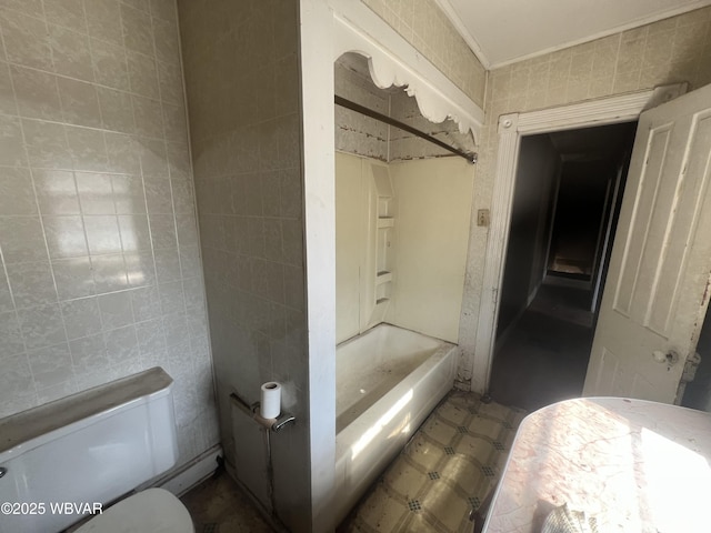 full bathroom featuring tile patterned floors, toilet, and tile walls