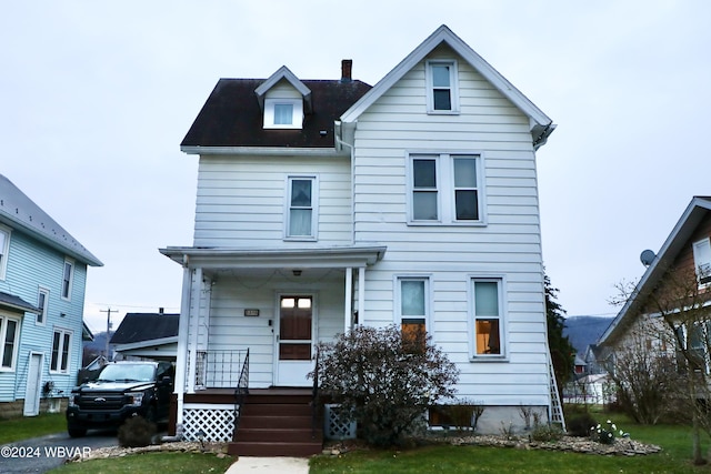 view of front of home with a front lawn and a porch