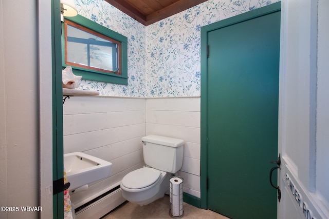 320 Carpenters Ln, Pennsdale, PA 17756 - half bath featuring wallpapered walls, wainscoting, toilet, and a baseboard heating unit