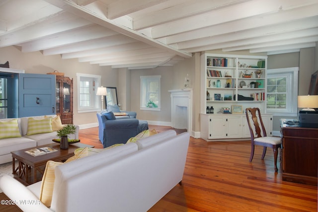 320 Carpenters Ln, Pennsdale, PA 17756 - living area featuring beamed ceiling, wood finished floors, baseboards, and a fireplace