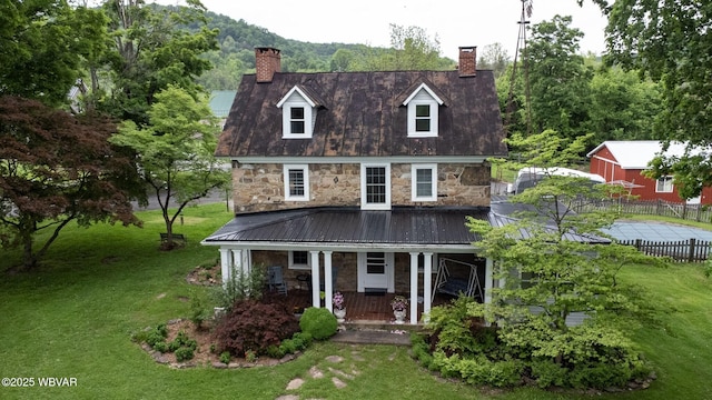 320 Carpenters Ln, Pennsdale, PA 17756 - cape cod home with stone siding, a chimney, and a porch