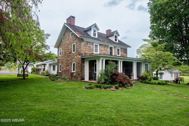 320 Carpenters Ln, Pennsdale, PA 17756 - view of front of property with stone siding, a chimney, and a front lawn
