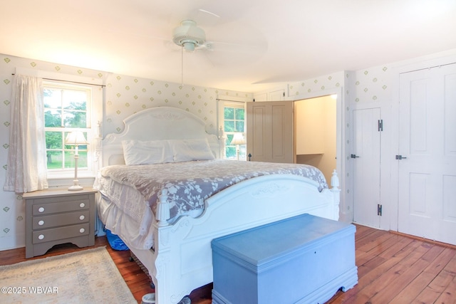 320 Carpenters Ln, Pennsdale, PA 17756 - bedroom with wallpapered walls, wood finished floors, a ceiling fan, and a closet