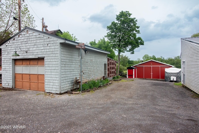 320 Carpenters Ln, Pennsdale, PA 17756 - view of side of home featuring a detached garage and an outbuilding