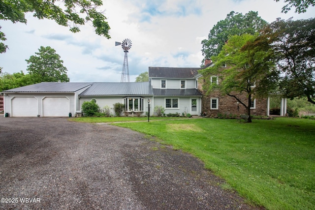 320 Carpenters Ln, Pennsdale, PA 17756 - view of front of house featuring a garage, driveway, a front yard, metal roof, and a chimney