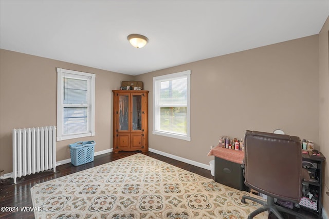 office with dark hardwood / wood-style flooring and radiator