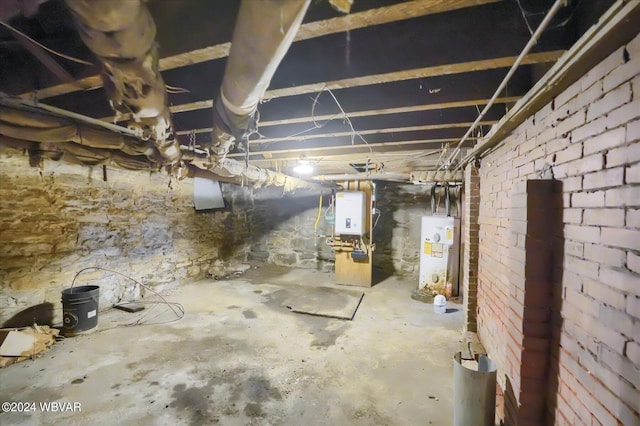 basement with brick wall and gas water heater