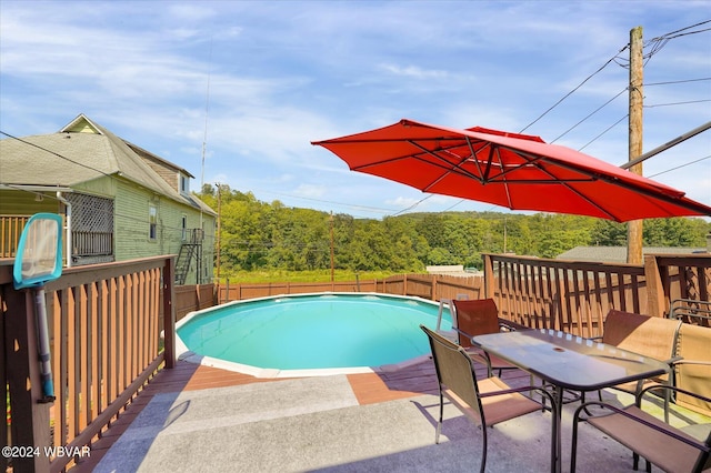 view of swimming pool with a deck