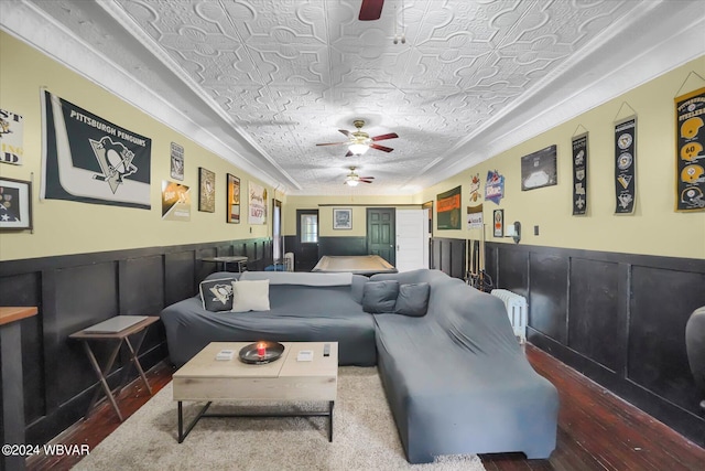 living room featuring wood-type flooring, a textured ceiling, ceiling fan, and radiator heating unit