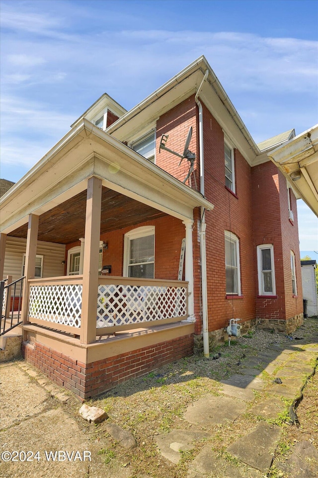 view of side of home featuring a porch