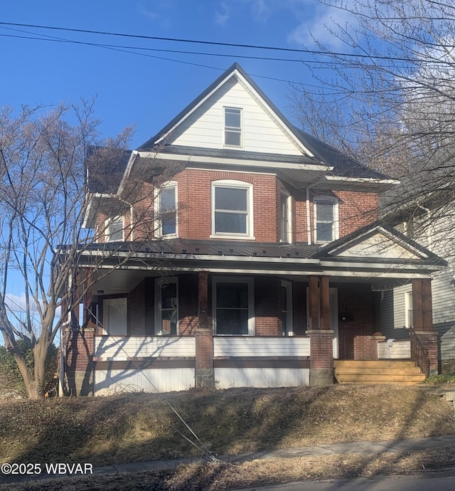 view of front of property featuring a porch and brick siding