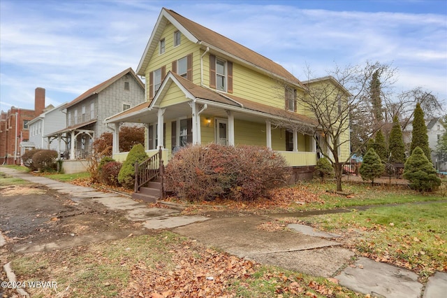 view of side of home with covered porch