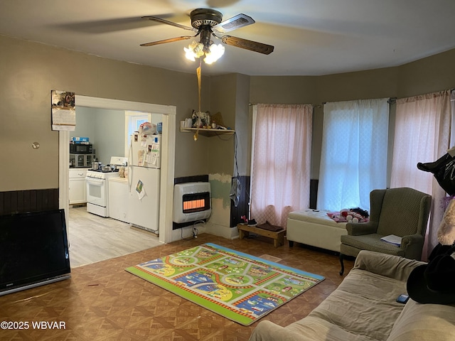 interior space with heating unit and ceiling fan