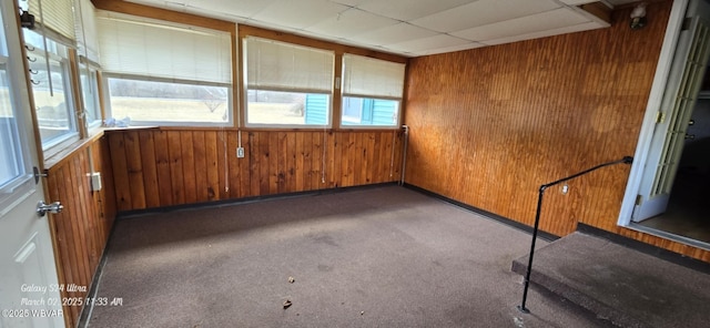 unfurnished sunroom featuring a drop ceiling