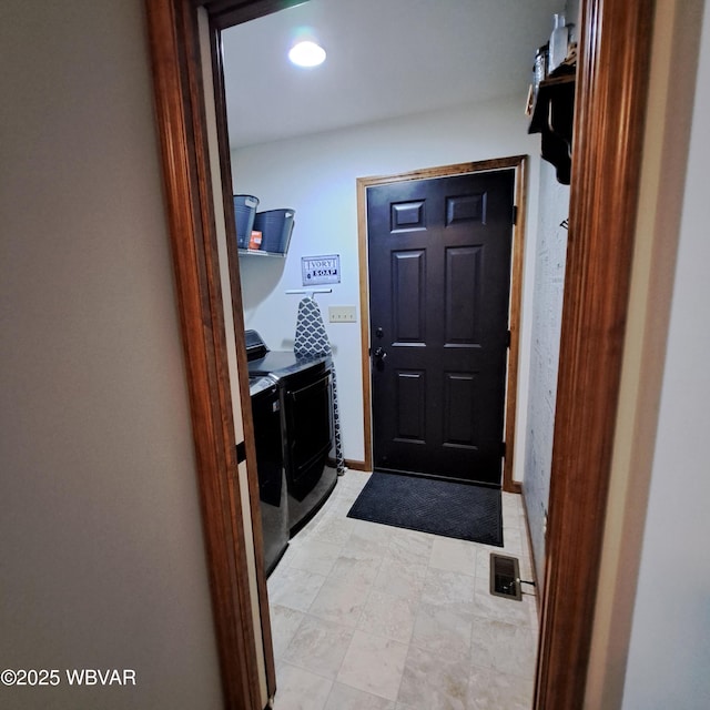 interior space featuring visible vents, baseboards, laundry area, and washer and clothes dryer