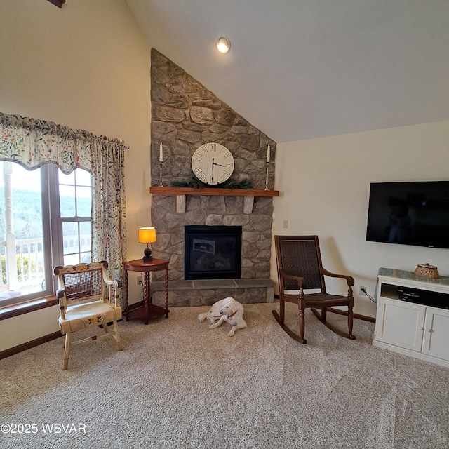 carpeted living area featuring a fireplace, baseboards, and high vaulted ceiling