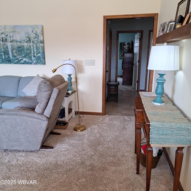 living room featuring carpet and baseboards