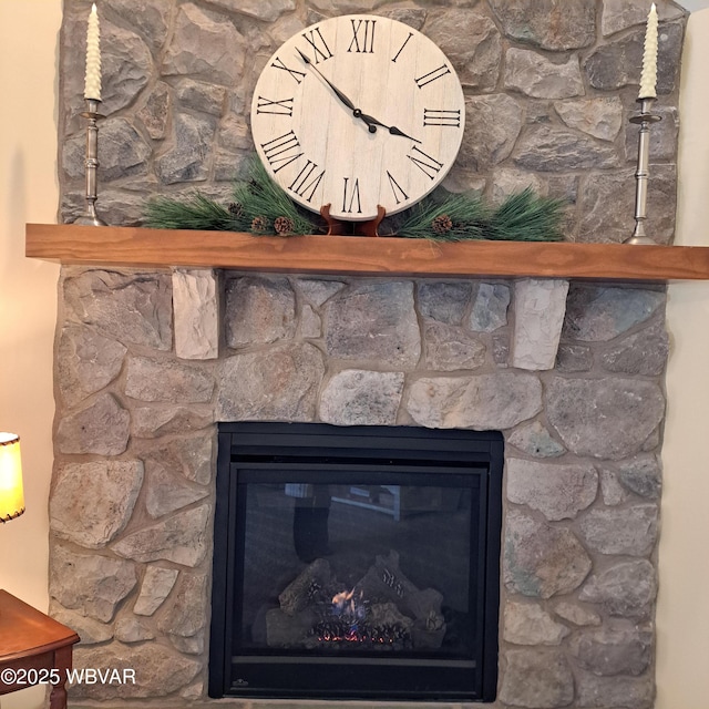 interior details with a stone fireplace