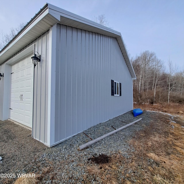 view of property exterior with an outbuilding