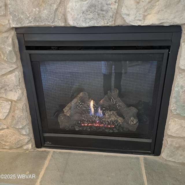 room details featuring a stone fireplace