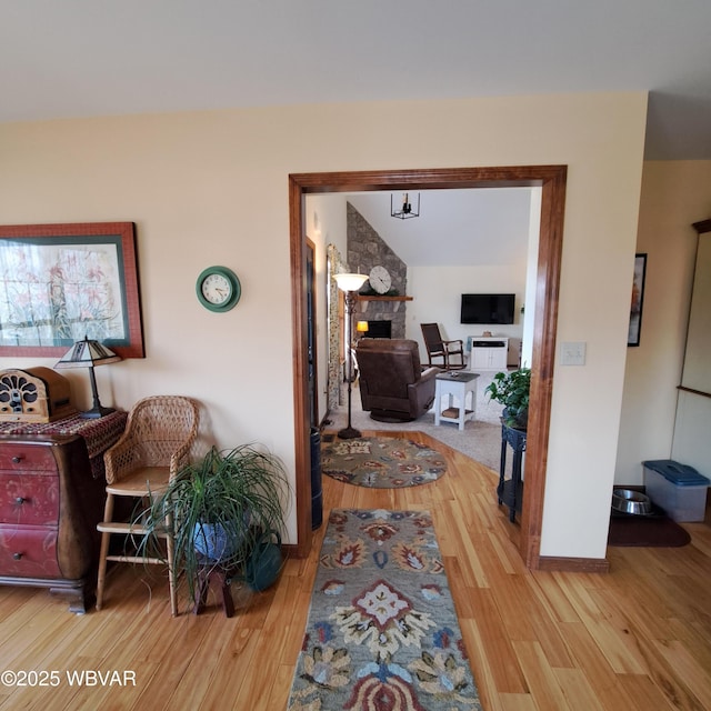 hall featuring wood finished floors and baseboards