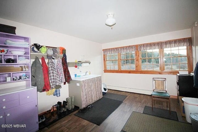 interior space featuring dark wood-type flooring, sink, and baseboard heating