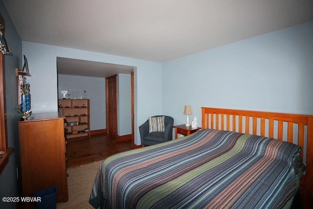 bedroom with dark hardwood / wood-style flooring