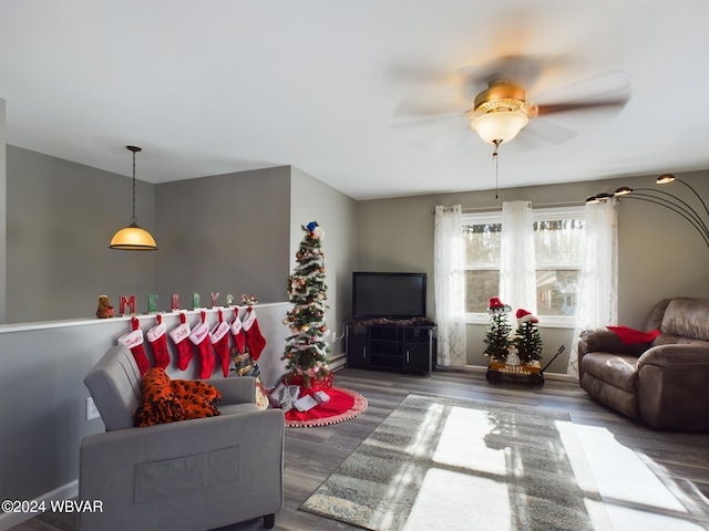 living room with dark hardwood / wood-style flooring and ceiling fan