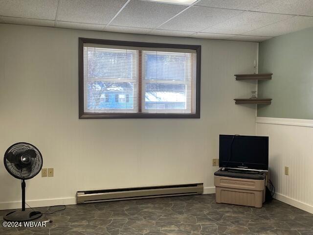 misc room with a drop ceiling and a baseboard radiator