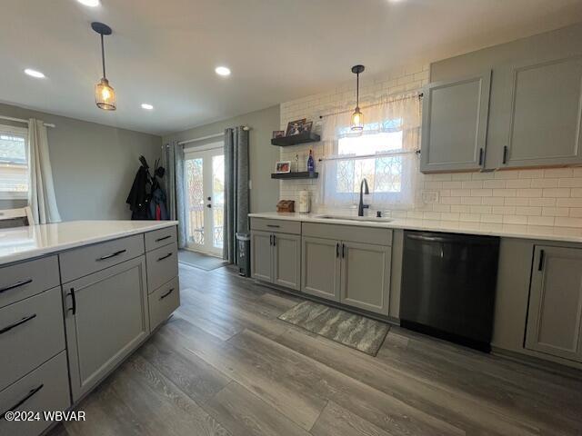 kitchen featuring dishwasher, gray cabinetry, a healthy amount of sunlight, and sink