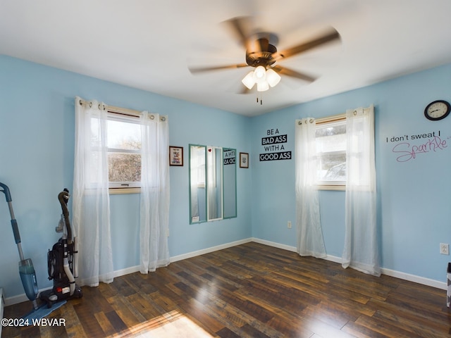 unfurnished room with ceiling fan and dark hardwood / wood-style flooring