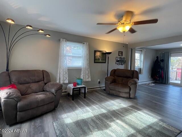 living room featuring dark hardwood / wood-style floors, a baseboard radiator, and ceiling fan