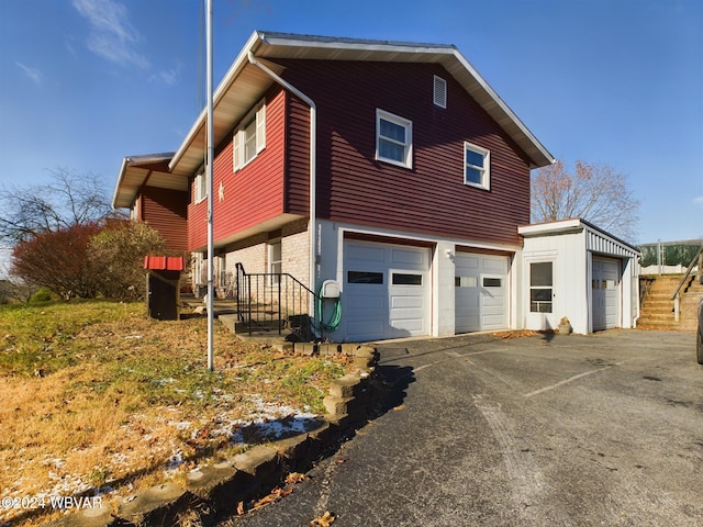 view of side of property with a garage