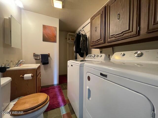 washroom featuring separate washer and dryer and sink