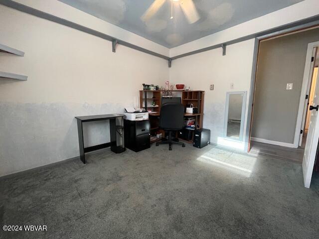 home office with dark carpet and ceiling fan