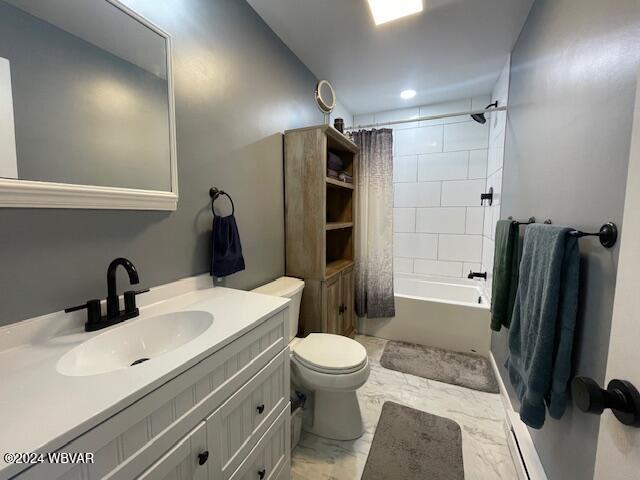 full bathroom with vanity, shower / bath combo, and toilet