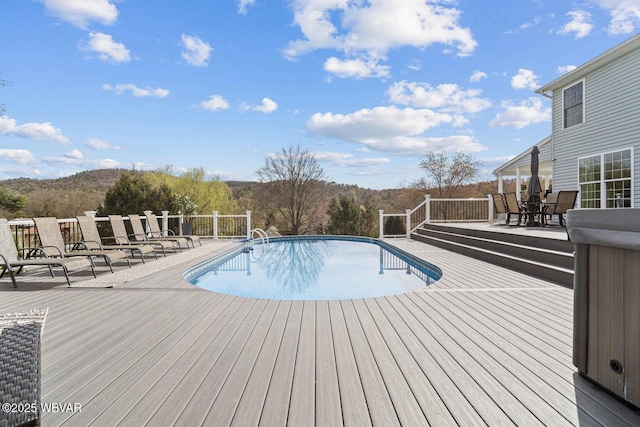 view of swimming pool with a wooden deck