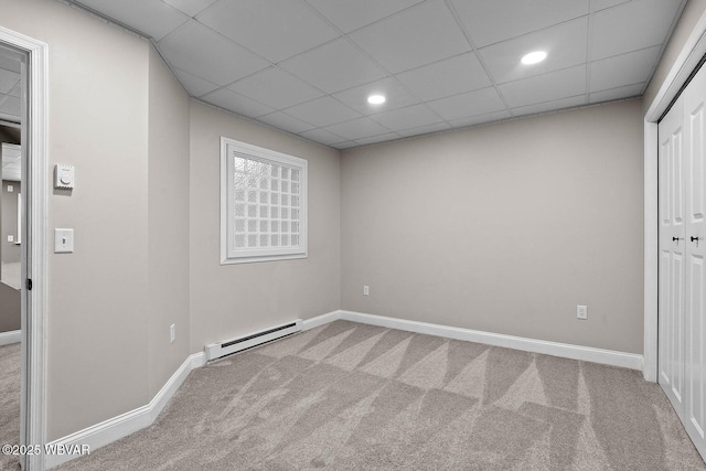 carpeted empty room featuring baseboard heating, baseboards, recessed lighting, and a paneled ceiling