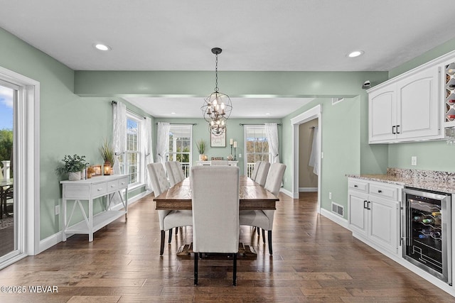dining space with beverage cooler, dark wood finished floors, baseboards, and recessed lighting