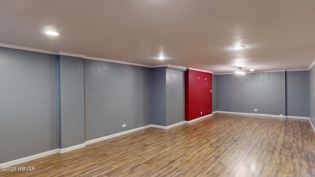 basement featuring hardwood / wood-style flooring and ornamental molding