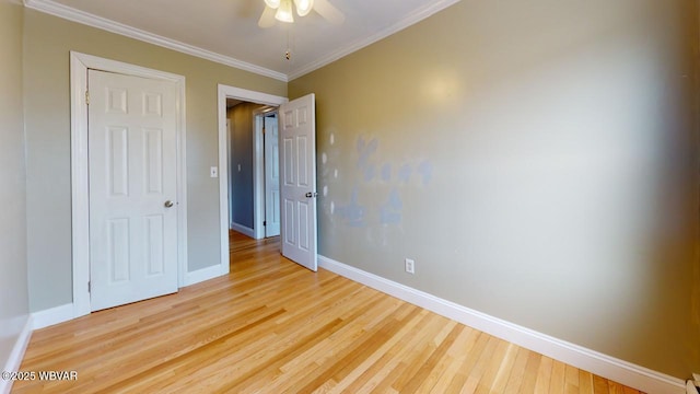 unfurnished bedroom featuring crown molding, light hardwood / wood-style floors, and ceiling fan