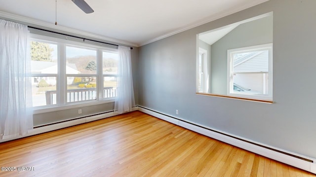 unfurnished room featuring baseboard heating, ornamental molding, and wood-type flooring