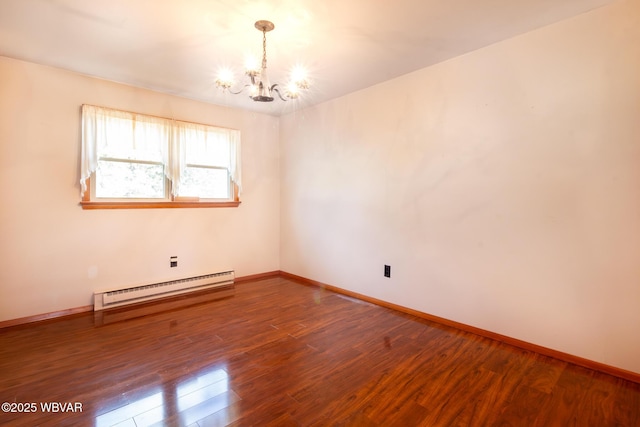 empty room featuring hardwood / wood-style floors, an inviting chandelier, and a baseboard radiator