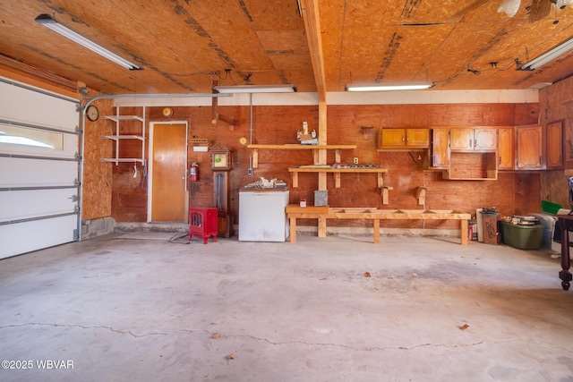 garage with a workshop area and fridge