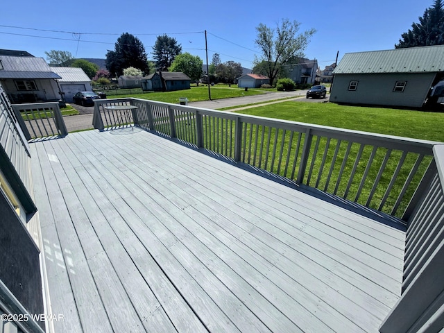 wooden terrace featuring a residential view and a lawn