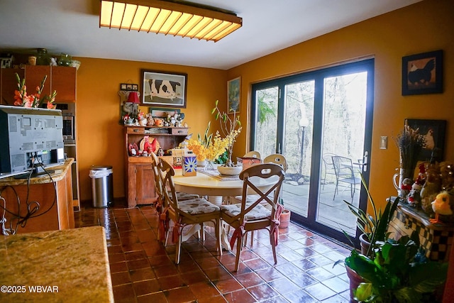 dining space with dark tile patterned flooring