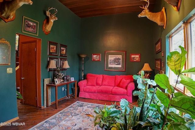 living area featuring wood finished floors, lofted ceiling, and wooden ceiling