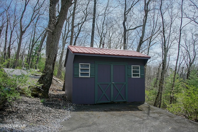 view of shed featuring a wooded view
