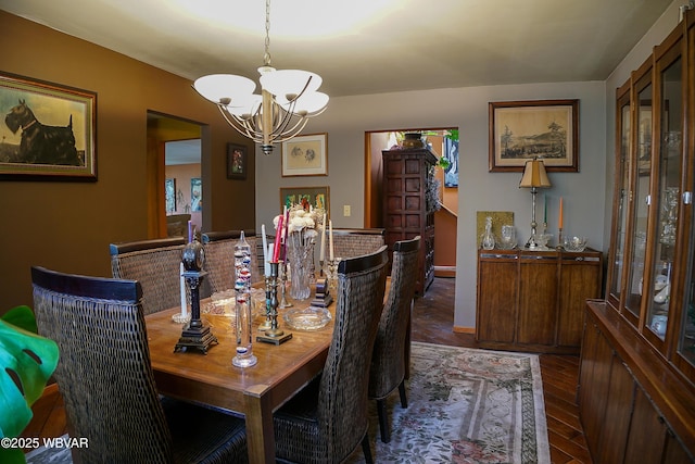 dining room featuring an inviting chandelier and dark wood-style floors